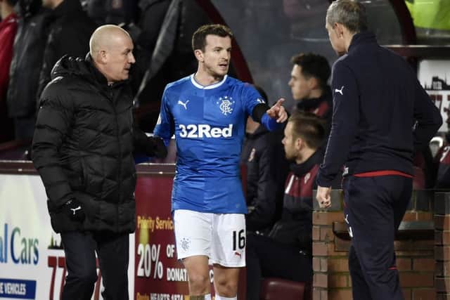 Rangers manager Mark Warburton (left) and assistant manager Davie Weir (right) speak with Andy Halliday during the defeat to Hearts. Picture: SNS