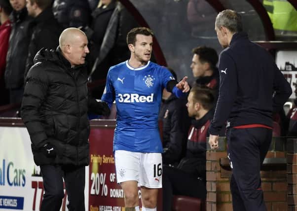 Rangers manager Mark Warburton (left) and assistant manager Davie Weir (right) speak with Andy Halliday during the defeat to Hearts. Picture: SNS