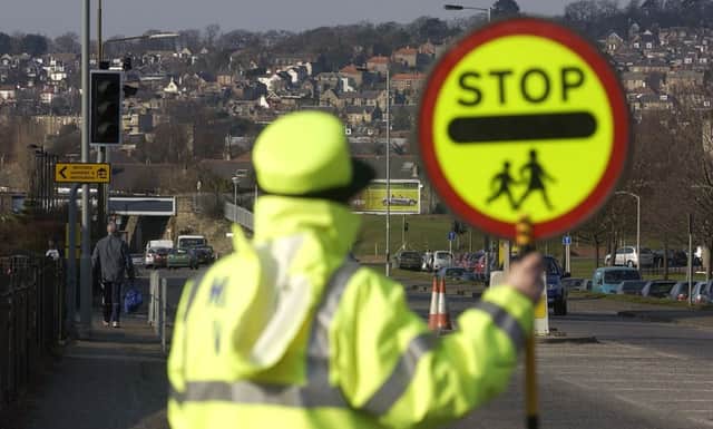 The number of lollipop men and women across Scotland has fallen over the last three years. Picture: Toby Williams/TSPL