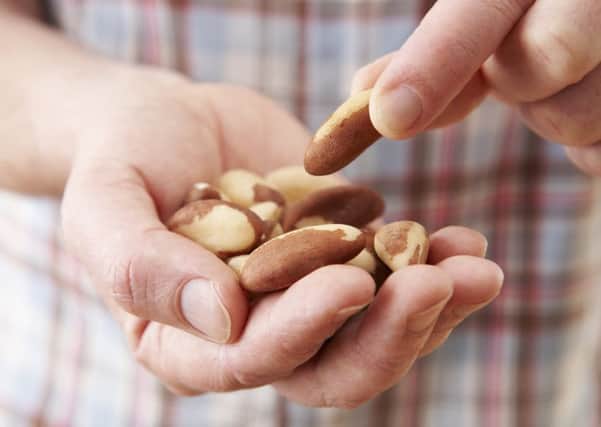 New analysis finds eating a handful of nuts each day could reduce the risk of disease.