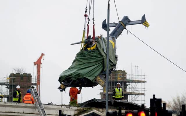 Helicopter being removed from the Clutha pub. Picture: SWNS