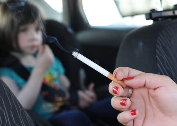 Smoking in a car with children will now attract a minimum fine of £100. Picture: John Devlin