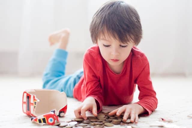 Rather than raiding their whole piggy bank, a small portion of cash could be set aside for a child to spend how they like, helping them to learn about budgets. Photograph: PA