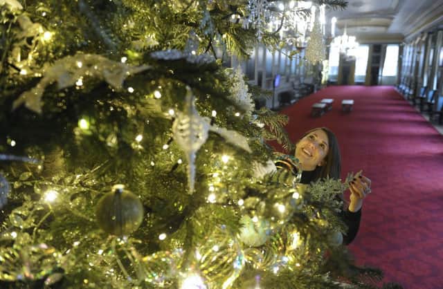 Staff decorate a 15ft Christmas tree in the state apartments at the Palace of Holyroodhouse. Picture: Neil Hanna/JP LIcense