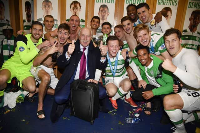 Majority shareholder Dermot Desmond joins the Celtic players in the dressing room after they had beaten Aberdeen in the Betfred Cup final