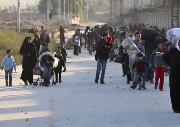 People fleeing rebel-held eastern neighborhoods of Aleppo into the Sheikh Maqsoud area that is controlled by Kurdish fighters, Syria. Picture: The Rumaf via AP