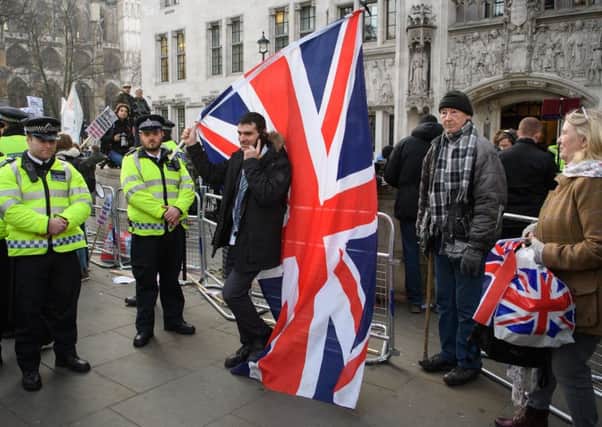 Pro-Leave supporters gather outside the Supreme Court on the first day of the Article 50 hearing.