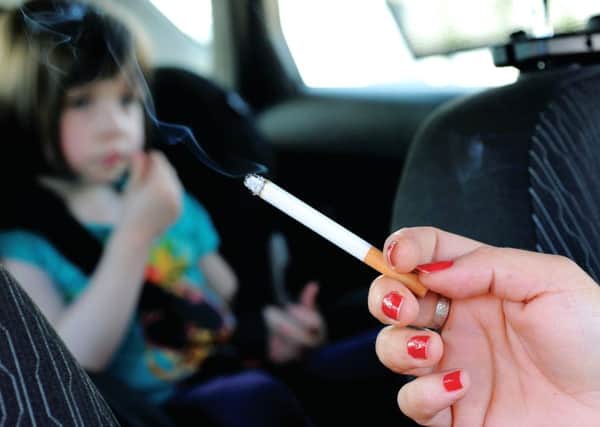 Smoking in a car with children will now attract a minimum fine of £100. Picture: John Devlin