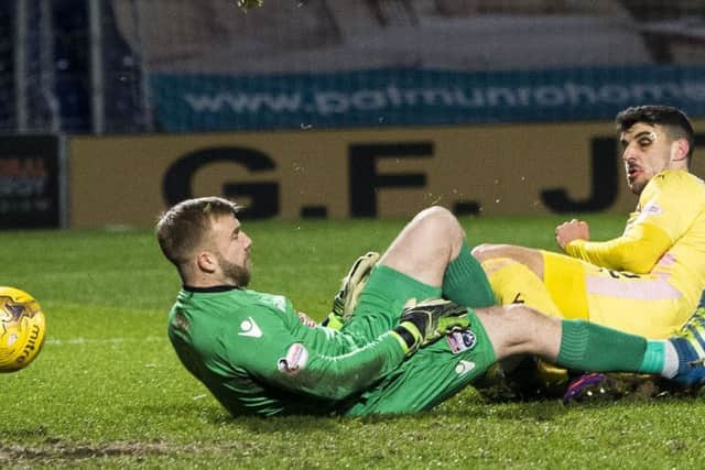 Callum Paterson slides in to poke the ball past Ross County goalkeeper Scott Fox. Picture: SNS.