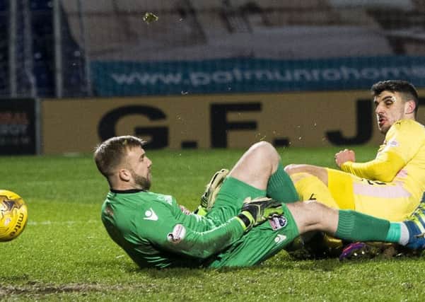 Callum Paterson slides in to poke the ball past Ross County goalkeeper Scott Fox. Picture: SNS.