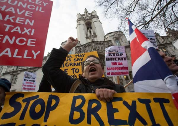 Anti-Brexit demonstrators protest outside the Supreme court building in London on the first day of a four-day hearing on December 5, 2016. The government of Prime Minister Theresa May will today seek to overturn a ruling that it must obtain parliamentary approval before triggering Brexit, in a highly-charged case in Britain's highest court
