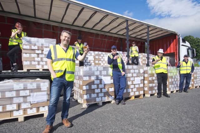 The Uisge Source team, led by Graeme Lindsay (front), raise a glass to their export success. Picture: Contributed