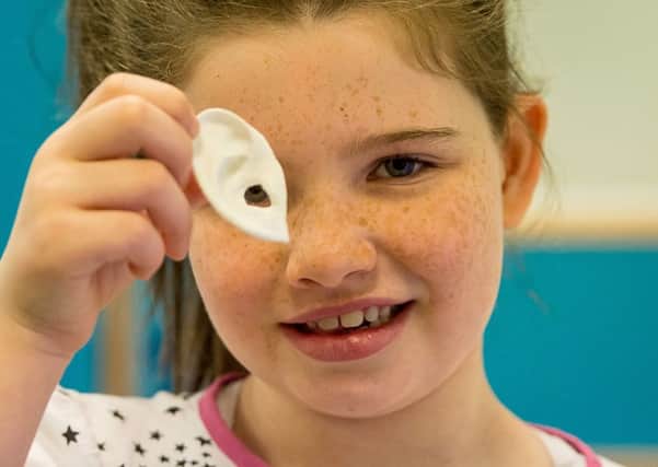 Anya Storie holds a 3D printed ear. Picture: Contributed