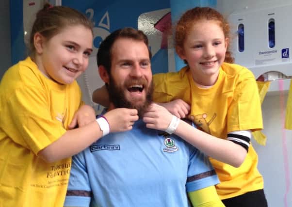 Caley Thistle goalkeeper Owain Fon Williams gets his beard pulled by Lakeisha Lapsley and Eilidh Smith during launch of Beards for Bairns. Picture: Contributed
