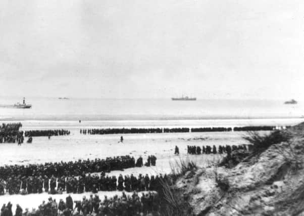 May 1940:  British Expeditionary Forces and French troops awaiting evacuation from the beach at Dunkirk.  (Photo by Topical Press Agency/Getty Images)