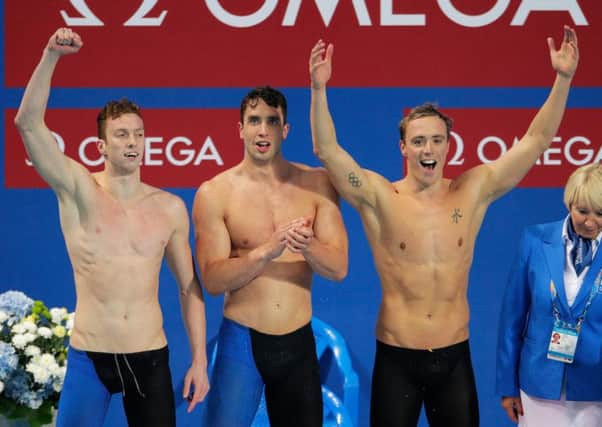 Daniel Wallace, Calum Jarvis and Robert Renwick (right) of Great Britain react after winning the gold medal in the Men's 4x200m Freestyle Relay final at the FINA World Championships in Kazan, Russia. Picture: Adam Pretty/Getty Images