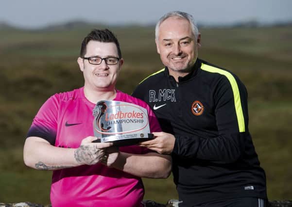 Tommy McKay receiving his award with Dundee United boss Ray McKinnon. Picture: SNS