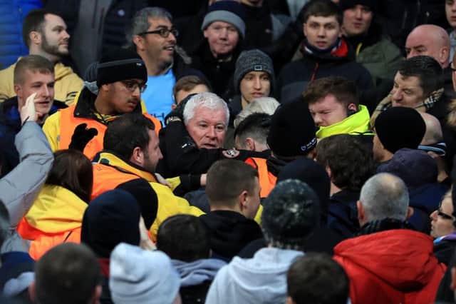 Stewards react to trouble in the crowd during the match between Celtic and Manchester City. Picture: PA