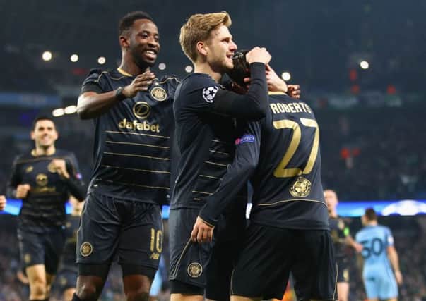 Patrick Roberts celebrates with Moussa Dembele and Stuart Armstrong after putting Celtic ahead at Etihad Stadium on Tuesday night. Picture: Clive Brunskill/Getty Images