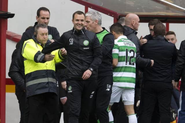 Celtic assistant manager Chris Davies (third from the left) after being involved in a touch-line incident at full-time in Saturday's game. Picture: SNS