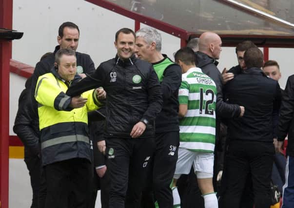 Celtic assistant manager Chris Davies (third from the left) after being involved in a touch-line incident at full-time in Saturday's game. Picture: SNS