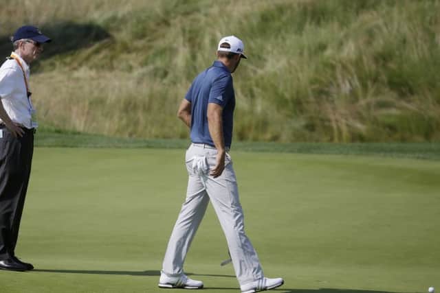 Dustin Johnson talks to a rules official during the final round of the US Open at Oakmont. Picture: John Minchillo/AP