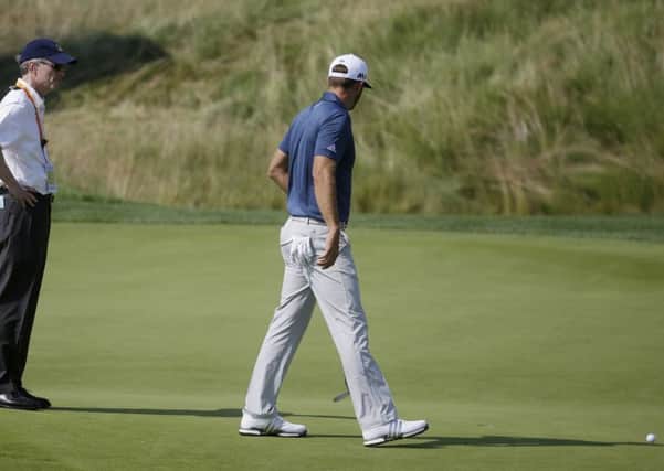 Dustin Johnson talks to a rules official during the final round of the US Open at Oakmont. Picture: John Minchillo/AP