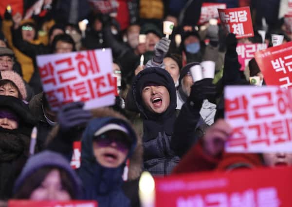 Protesters held a rally in Seoul yesterday calling for president Park Geun-hye to step down. Thousands of people demonstrated against her. Picture: AP