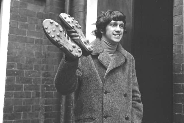 Eric Stevenson takes his boots as he leaves Easter Road for Ayr to meet manager Ally MacLeod in October 1971.