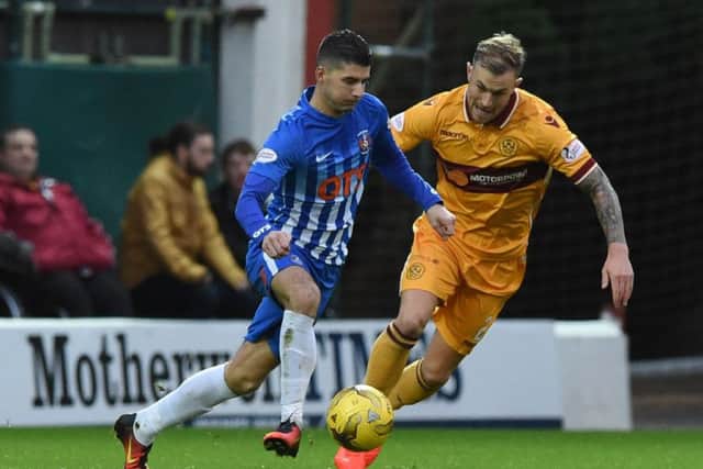 Motherwell's Richard Tait, right, battles for the ball against Kilmarnock's Jordan Jones. Pitcure: SNS