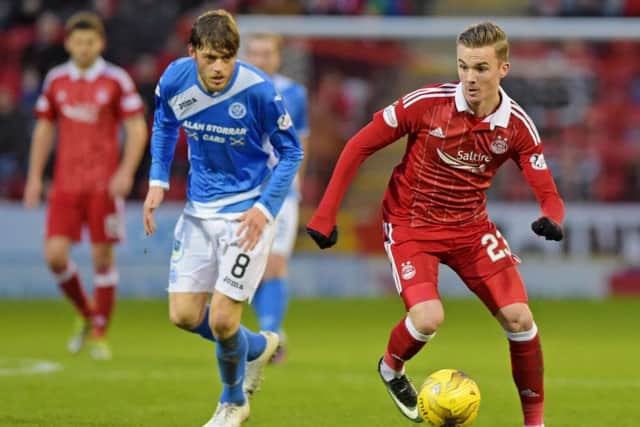Aberdeen's James Maddison, right, dribbles past St Johnstone's Murray Davidson. Picture: Alan Harvey/SNS