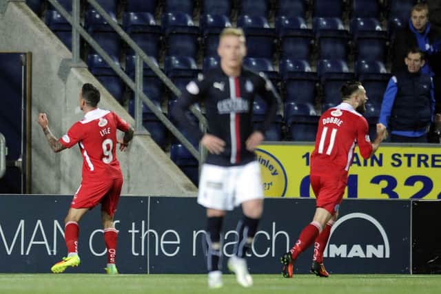 Queen of the South's Derek Lyle, left, celebrates equalising for his side at the Falkirk Stadium. Picture: Michael Gillen