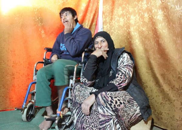 Kamila and her son Mahood in a makeshift tent in a small refugee camp in Lebanon.