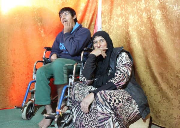 Kamila and her son Mahood in a makeshift tent in a small  refugee camp in Lebanon.