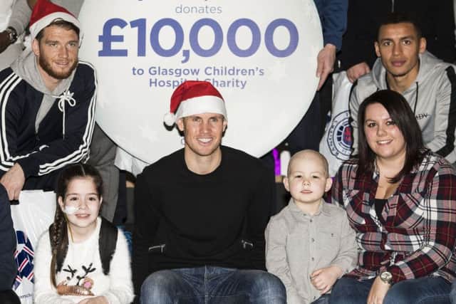 Kenny Miller, centre, Joe Garner, left, and James Tavernier visit the Royal Hospital for children in Glasgow. Picture: SNS.