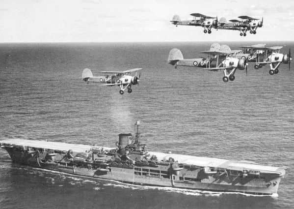 A fleet of Swordfish aircraft fly over HMS Ark Royal. Picture: Wiki Commons
