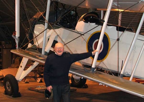 Lt Cdr Jock Moffat alongside a Swordfish aircraft similar to the one he flew during WW2. Picture: PA/MOD