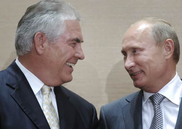 Russian President Vladimir Putin, right, and Rex Tillerson, ExxonMobil's chief executive. Picture: (Alexei Druzhinin/RIA Novosti via AP, Pool)