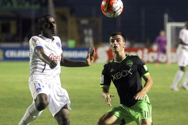 Aaron Kovar of Seattle Sounders, right, is to have a trial with Hibs. Picture: STR/AFP/Getty Images