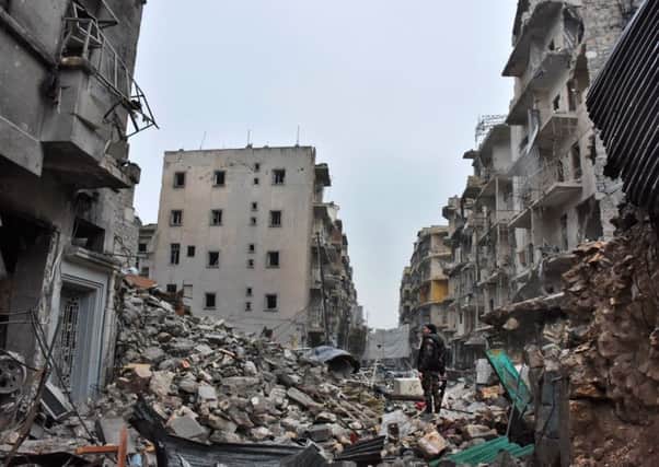 Pro-government forces walk in the Bustan al-Qasr area of Aleppo after it was recaptured. Picture: AFP/Getty Images