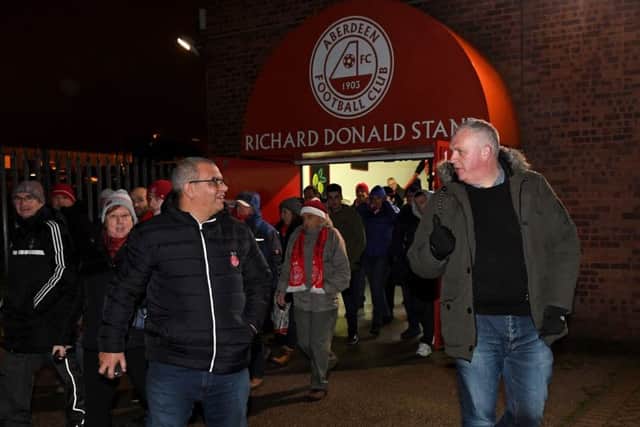 Aberdeen supporters leave Pittodrie after the game was abandoned due to floodlight failure. Picture: Craig Williamson/SNS