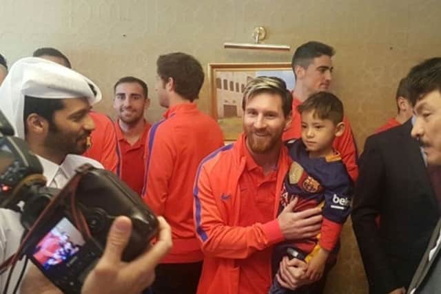 Lionel Messi with Murtaza Ahmadi in Qatar. Picture: AP