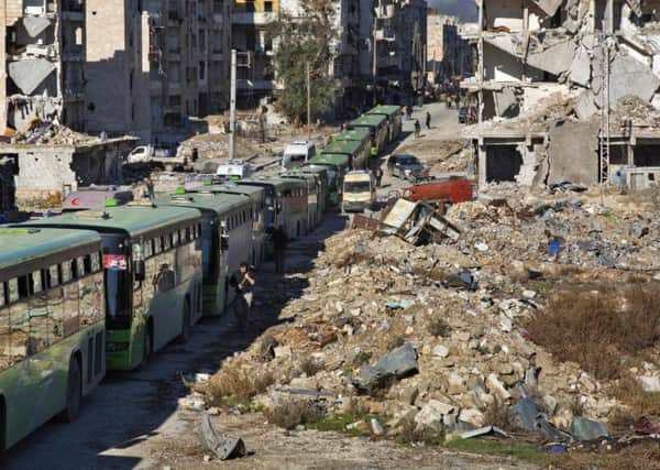 Buses line up to evacuate rebel fighters and their families from the embattled city of Aleppo yesterday. Picture: AFP/Getty Images