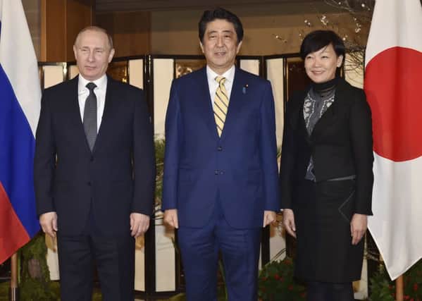 Russian President Vladimir Putin with Japanese Prime Minister Shinzo Abe, centre, and his wife, Akie. Picture: Kazuhiro Nogi/Pool Photo via AP