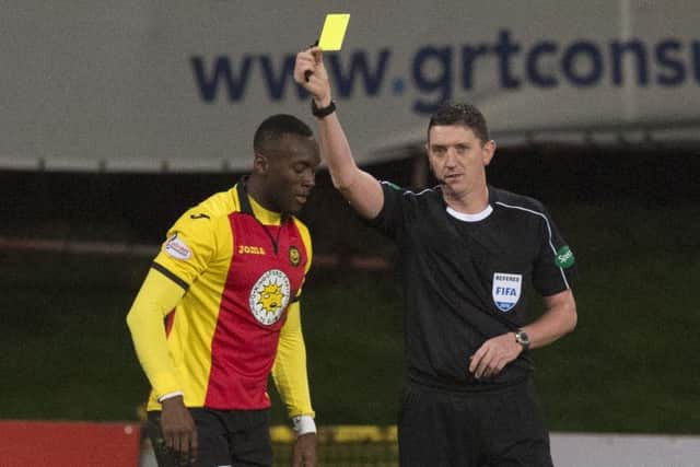 Ade Azeez was booked for diving following a clash with Craig Gordon. Picture: SNS