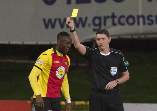 Ade Azeez was booked for diving following a clash with Craig Gordon. Picture: SNS
