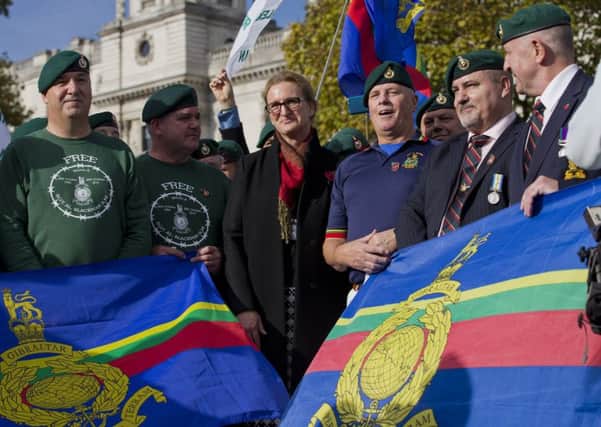 Claire Blackman, wife of jailed British Royal Marine Sergeant Alexander Blackman, poses with supporters wearing Royal Marine green berets during a rally in support of her husband. Picture: Getty Images
