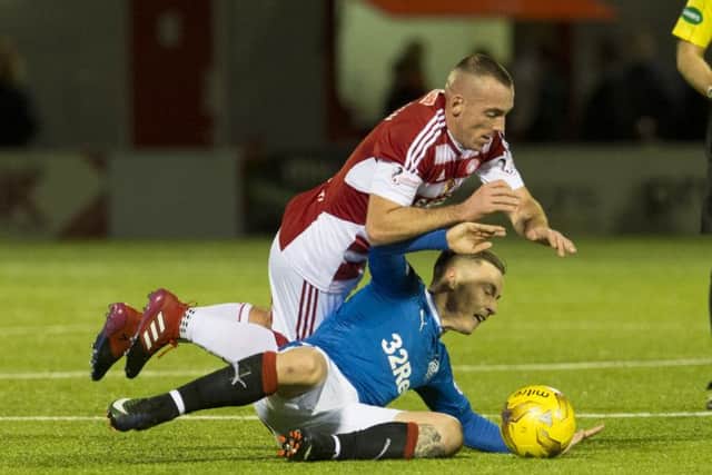 Accies' Darian MacKinnon fouls Barrie McKay during the first half. Picture: SNS