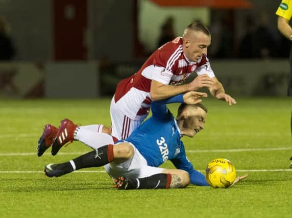 Accies' Darian MacKinnon fouls Barrie McKay during the first half. Picture: SNS