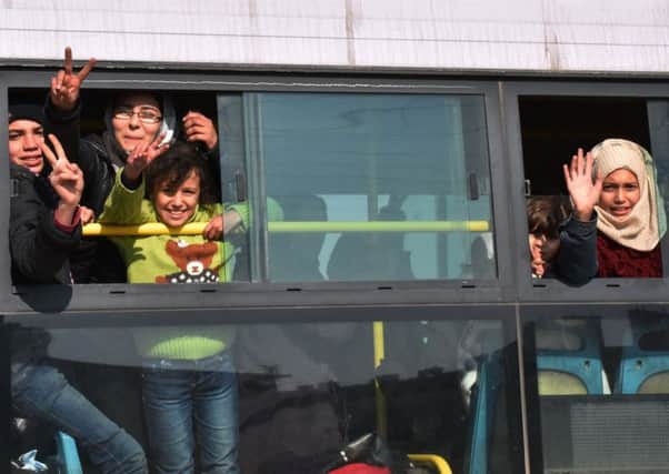 Syrians who were evacuated from the villages of Fuaa and Kafraya arrive in Jibrin on the eastern outskirts of Aleppo yesterday. Picture: AFP/Getty Images